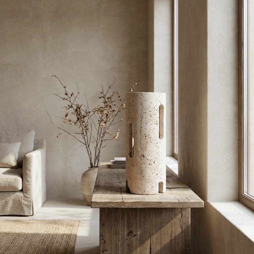 Toro table lamp, a natural travertine cylinder with small carved windows