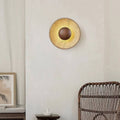 Hinode wall light, a natural travertine disc around a timber centre