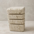 Tsumi table lamp, stacked natural travertine blocks glowing through the gaps